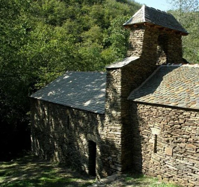 Stone chapel with a stone-slate roof in the forest