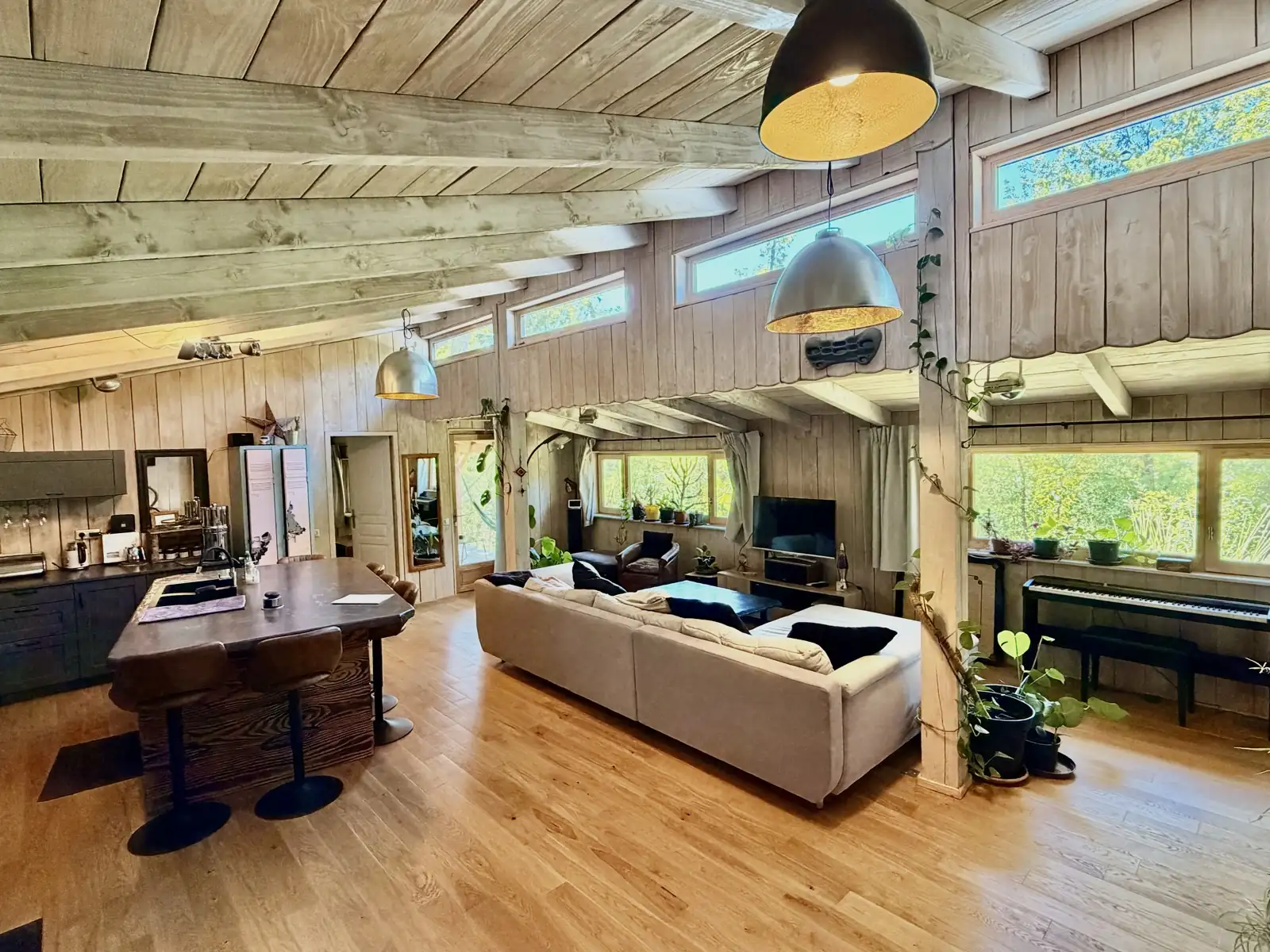Large wooden living room and kitchen with piano at Lalalandes